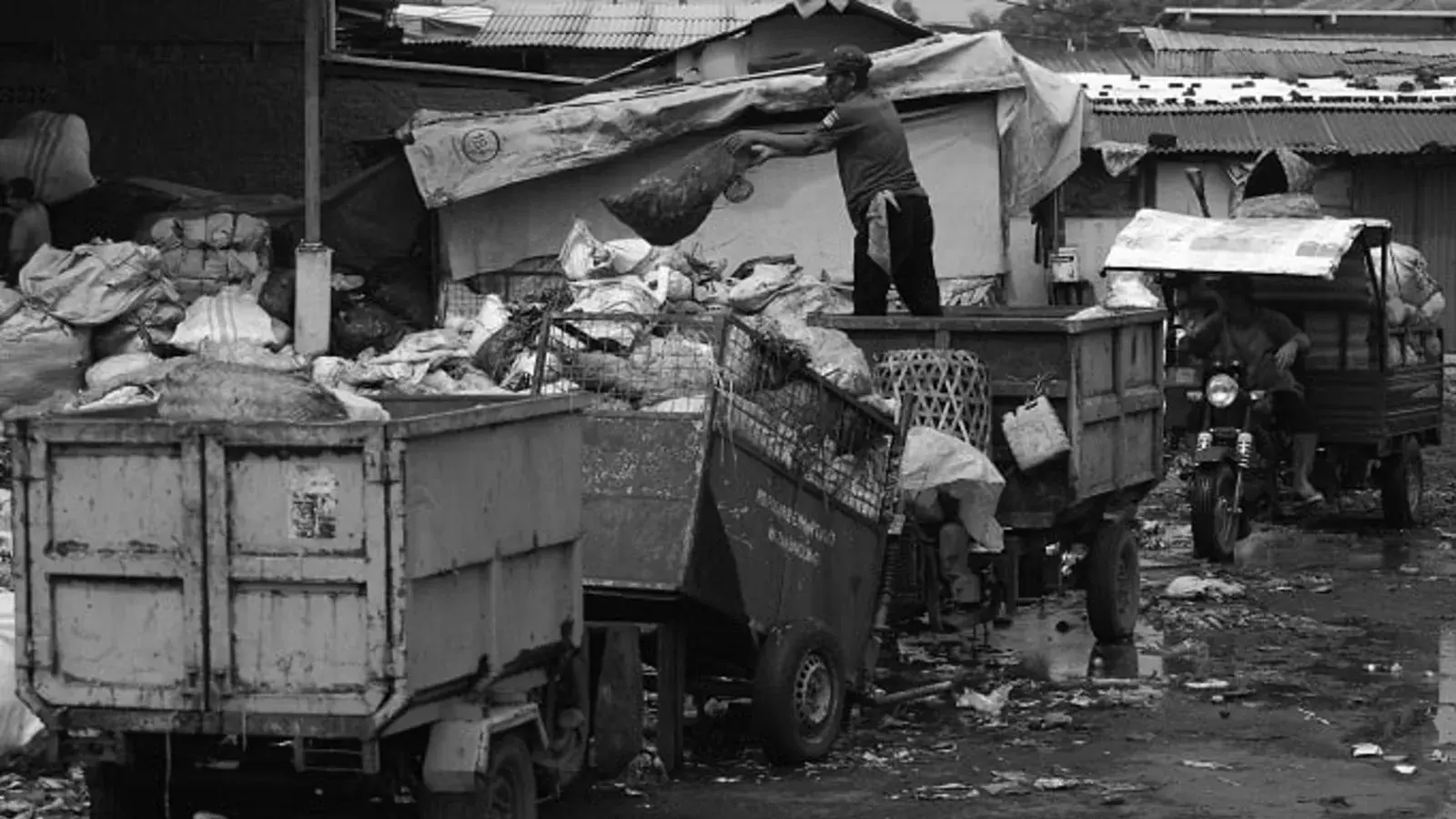 A compact urban waste processing centre in Bandung, with sorted waste being fed into a shredder and bales of fuel material stacked ready for collection