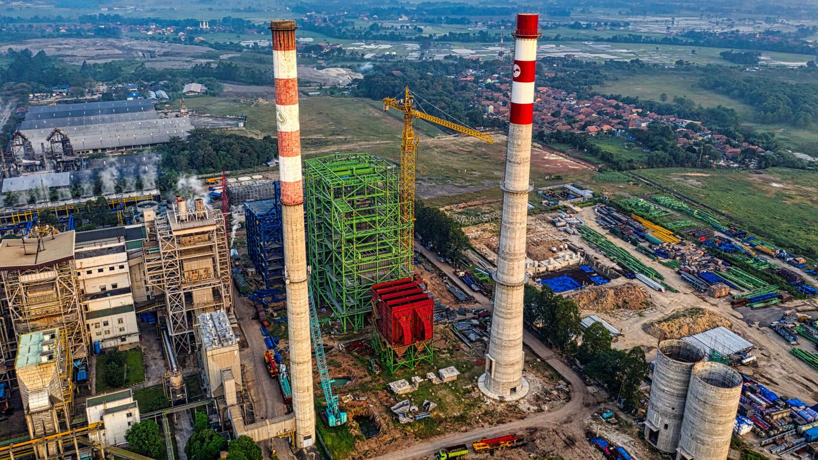 Aerial view of the Bantargebang integrated waste facility with cleared, levelled land prepared for a new waste-to-energy plant beside the existing landfill zones